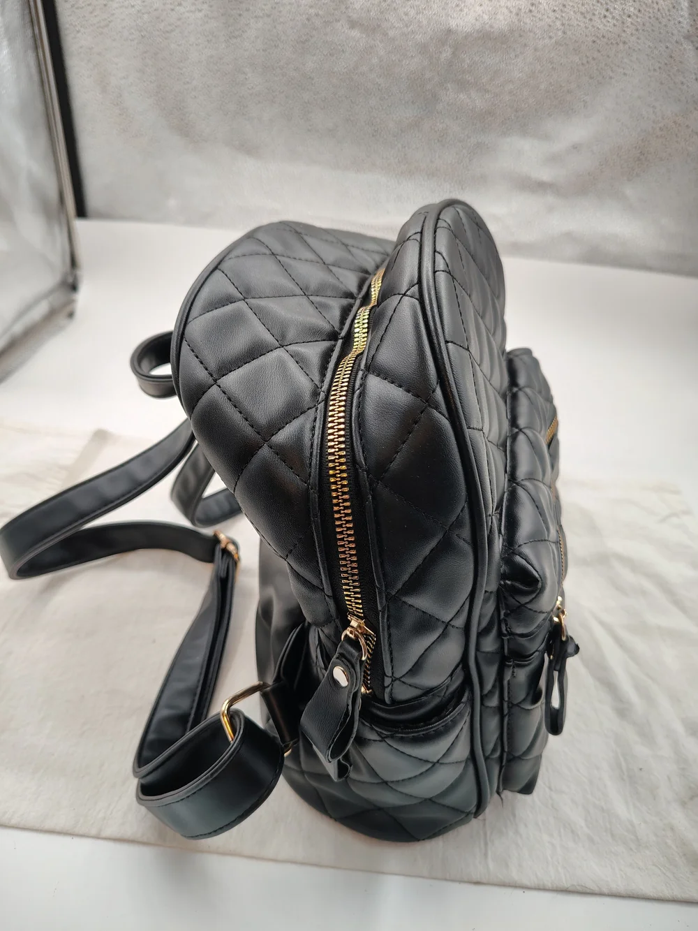 Quilted Black Mini Backpack with Gold Zip Accent